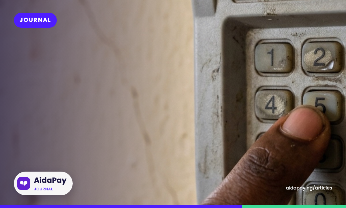 Macro close-up of a finger pressing a button on a prepaid electricity meter keypad