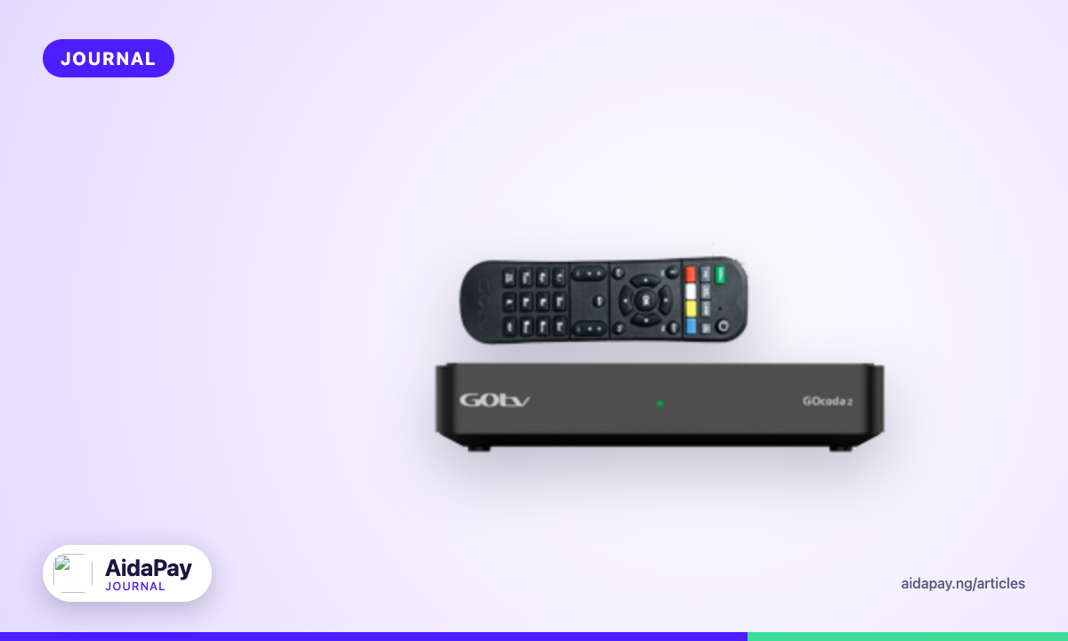 A satellite TV decoder and its remote control on a TV stand in a Nigerian living room