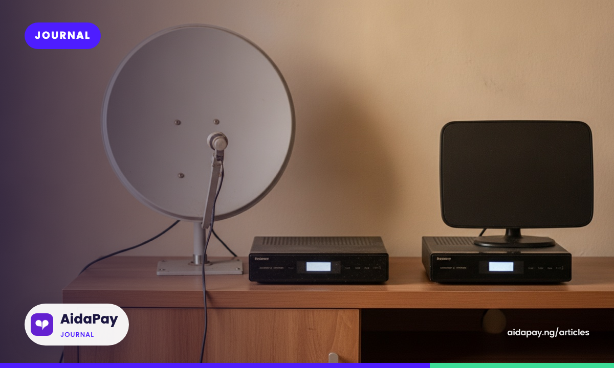 A satellite dish and an antenna, each beside its own decoder box, on a wooden TV stand